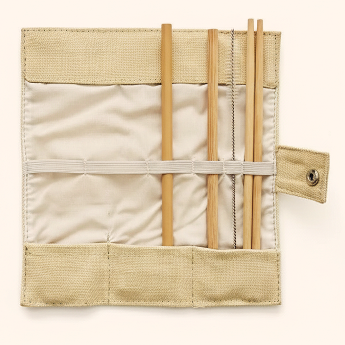 Open cloth pouch showing the bamboo straw and brush held by an elastic band
