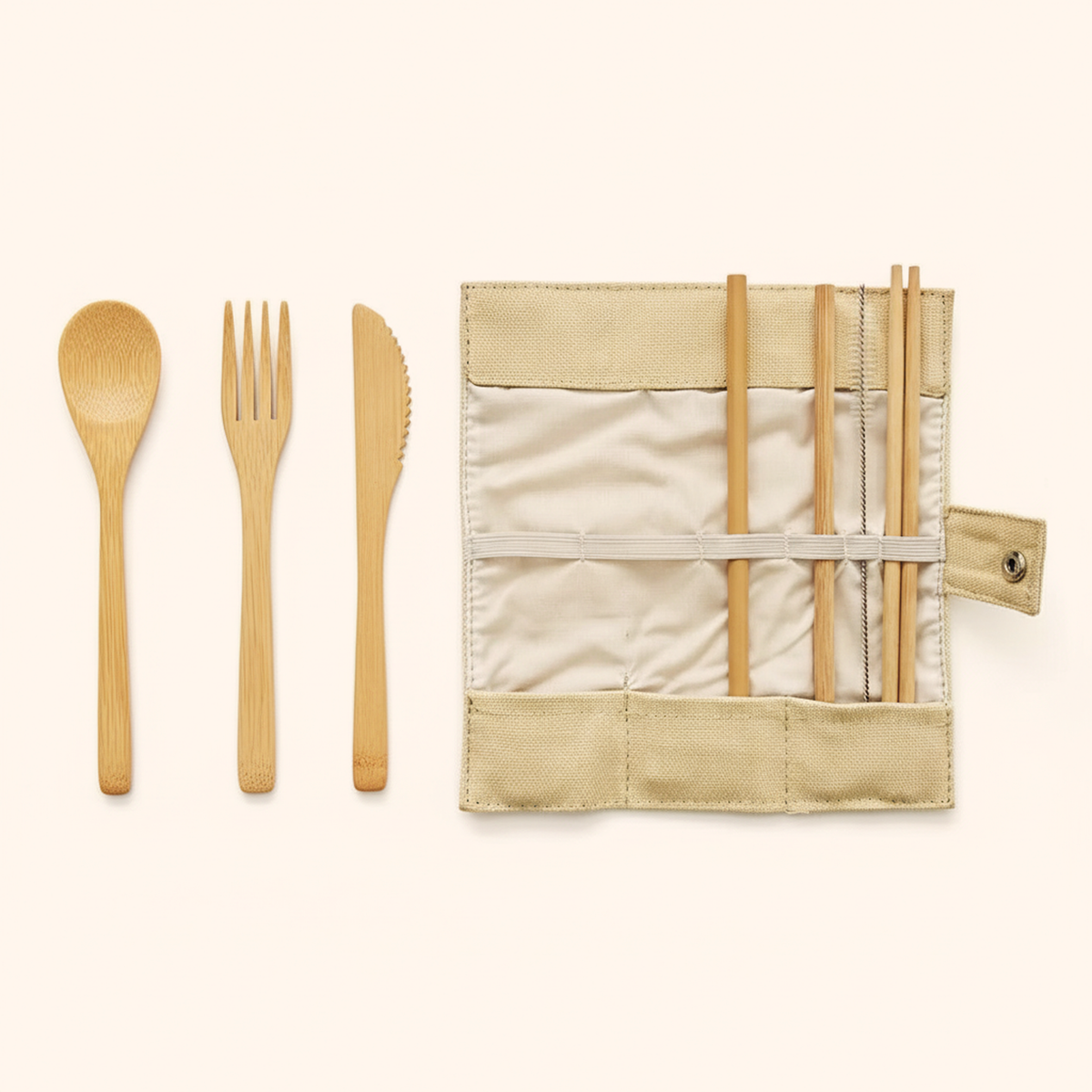 Bamboo spoon, fork and knife beside the open pouch holding the straw and brush
