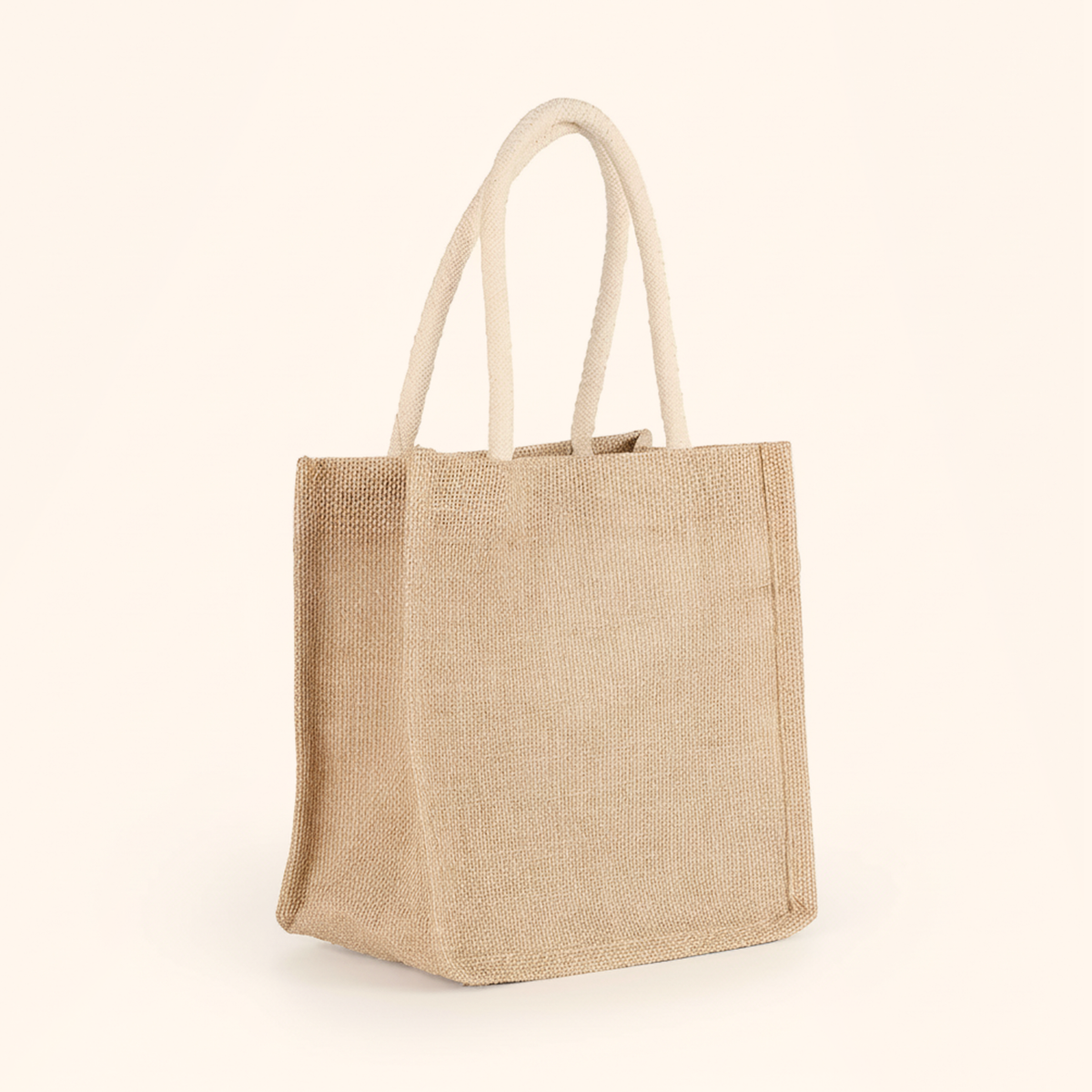 The empty woven tote bag standing upright with its handles raised, on cream