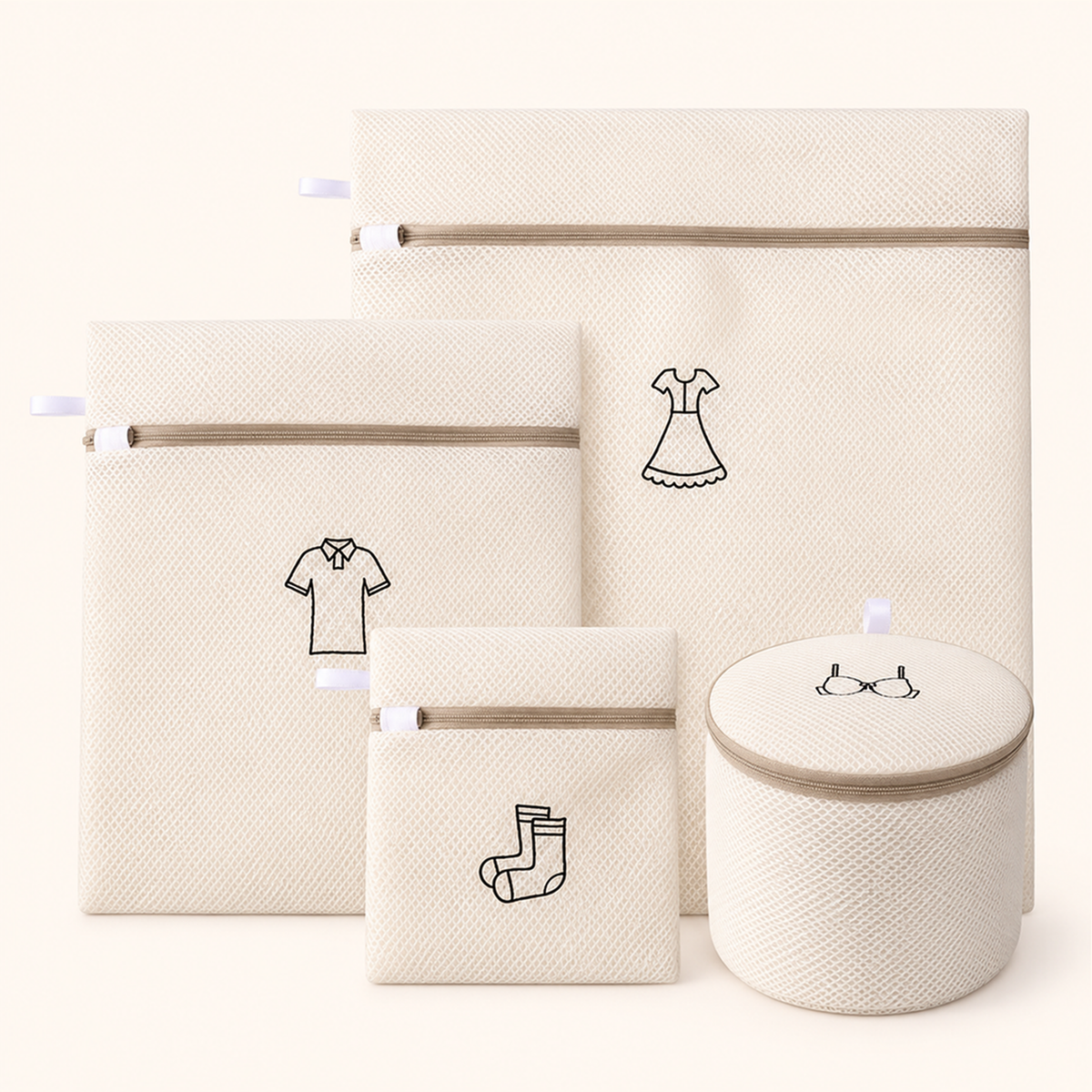 Set of four cream mesh bags in different sizes and shapes, arranged together