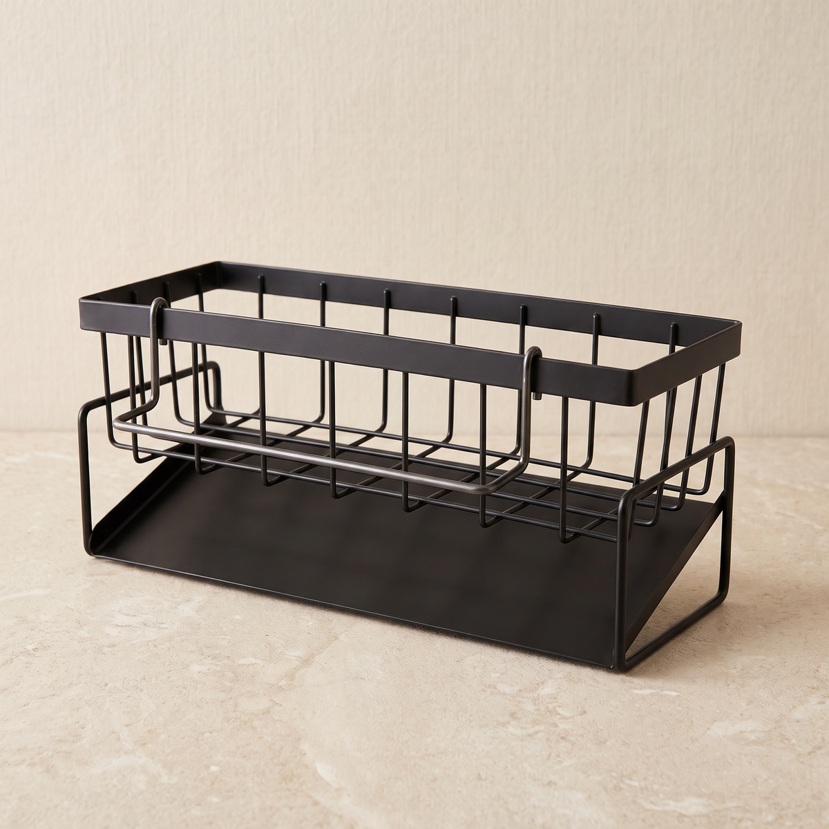 Front view of the empty black sink caddy on a pale stone worktop