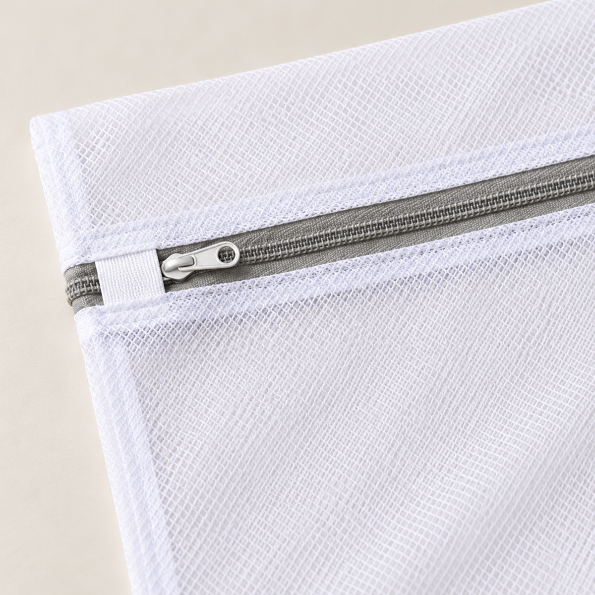 Close-up of honeycomb mesh, grey zip and the band the pull tucks under