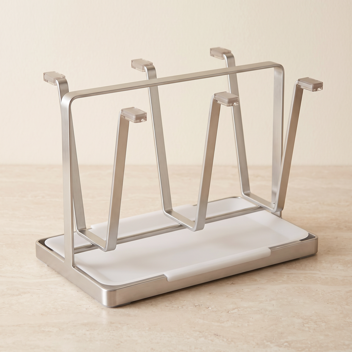 Stainless steel cup holder with six arms on a stone worktop