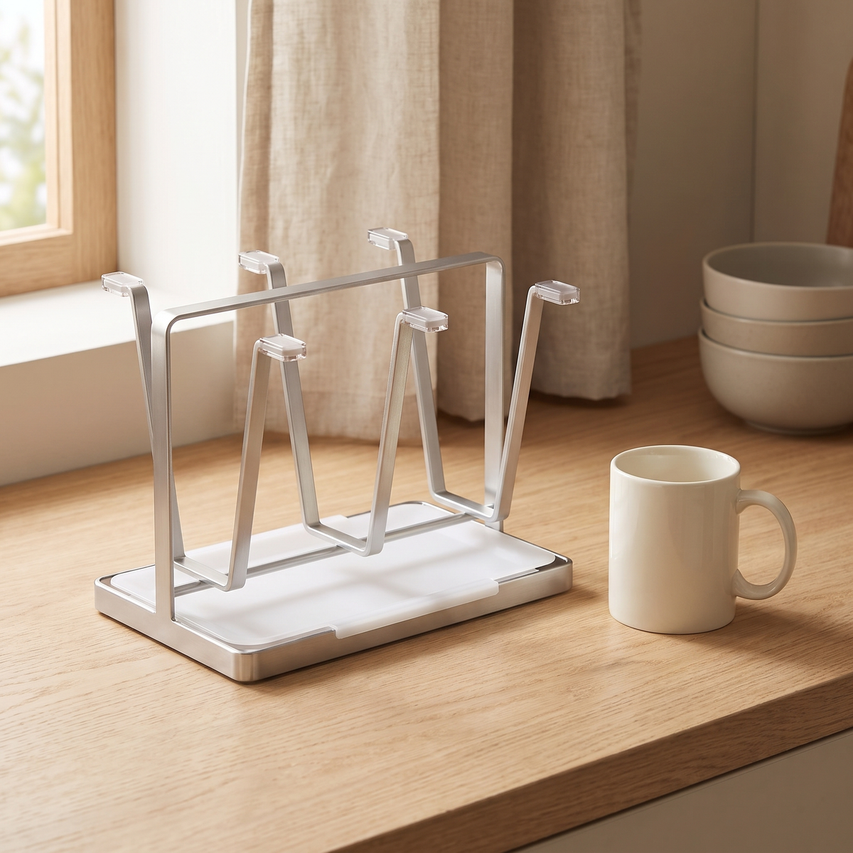 Empty rack on a wooden worktop beside a mug and bowls