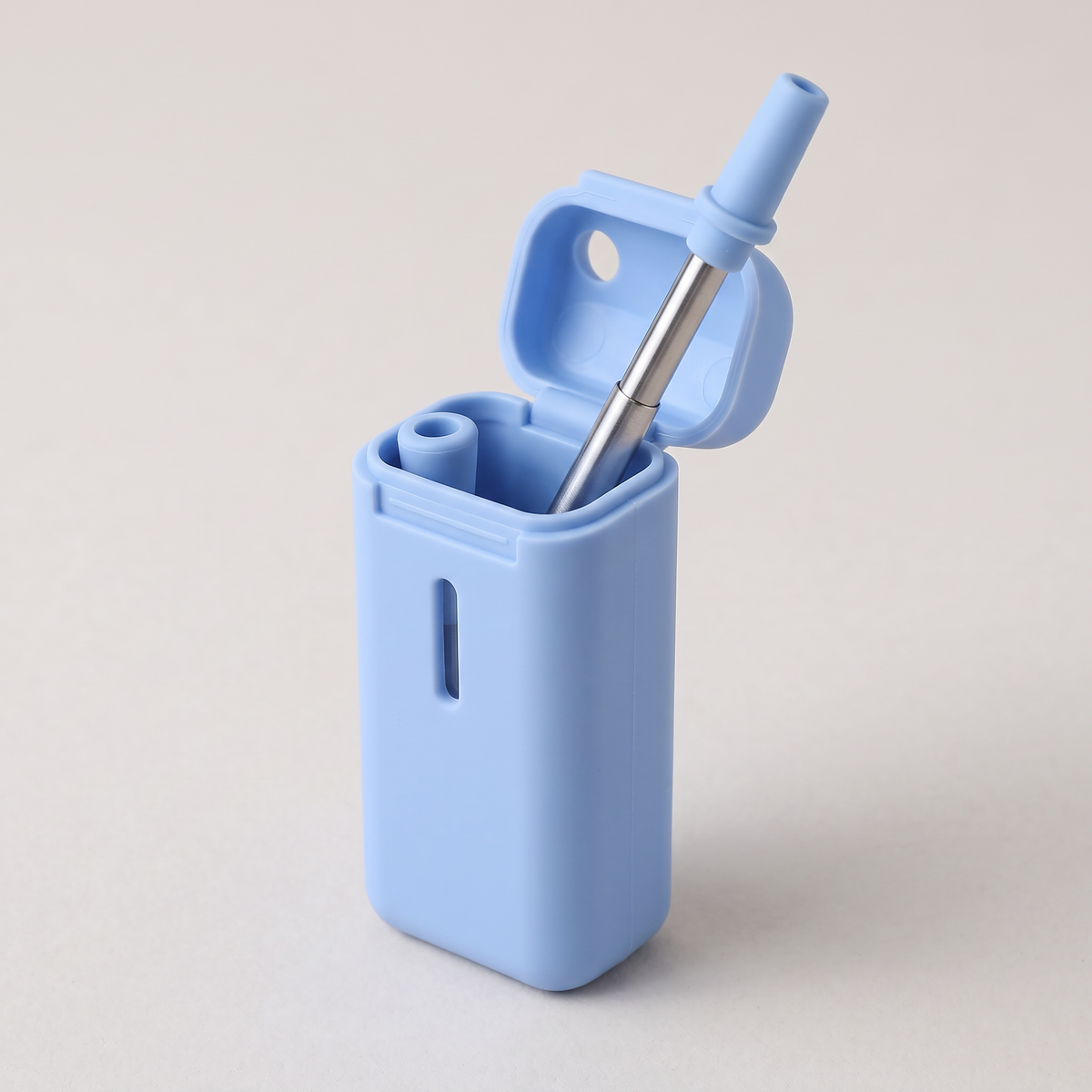 The blue case with its lid open and the straw partly pulled out