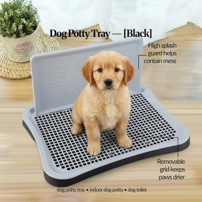Black indoor dog potty tray with splash guard and removable grid, shown with a golden puppy sitting on top; on-image notes about containing mess and keeping paws drier.