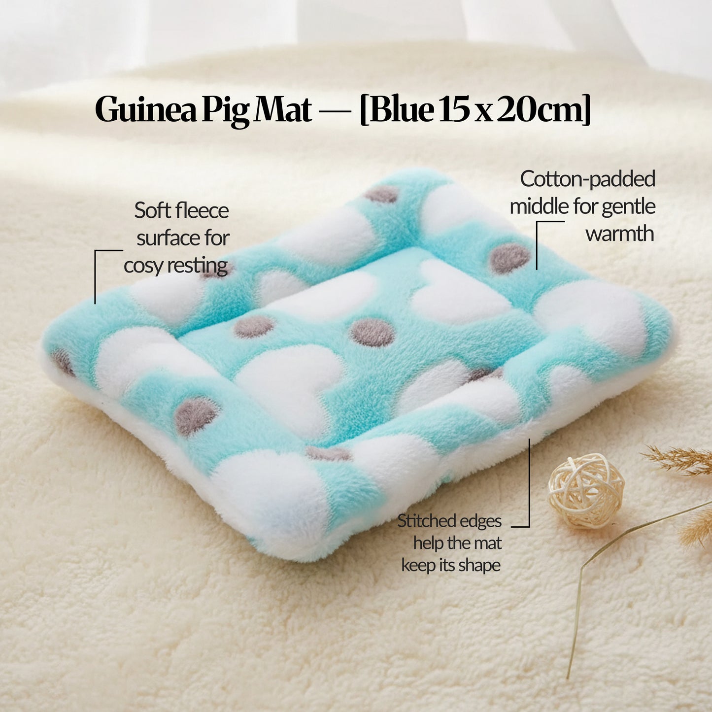 Blue guinea pig bed mat (15×20cm) soft fleece, cotton-padded mat with stitched edges, shown on a cosy cream surface with feature callouts.