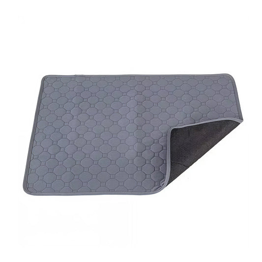 Product on white background: Grey quilted guinea pig cage liner photographed on white with one corner folded back to show the dark non-slip underside.