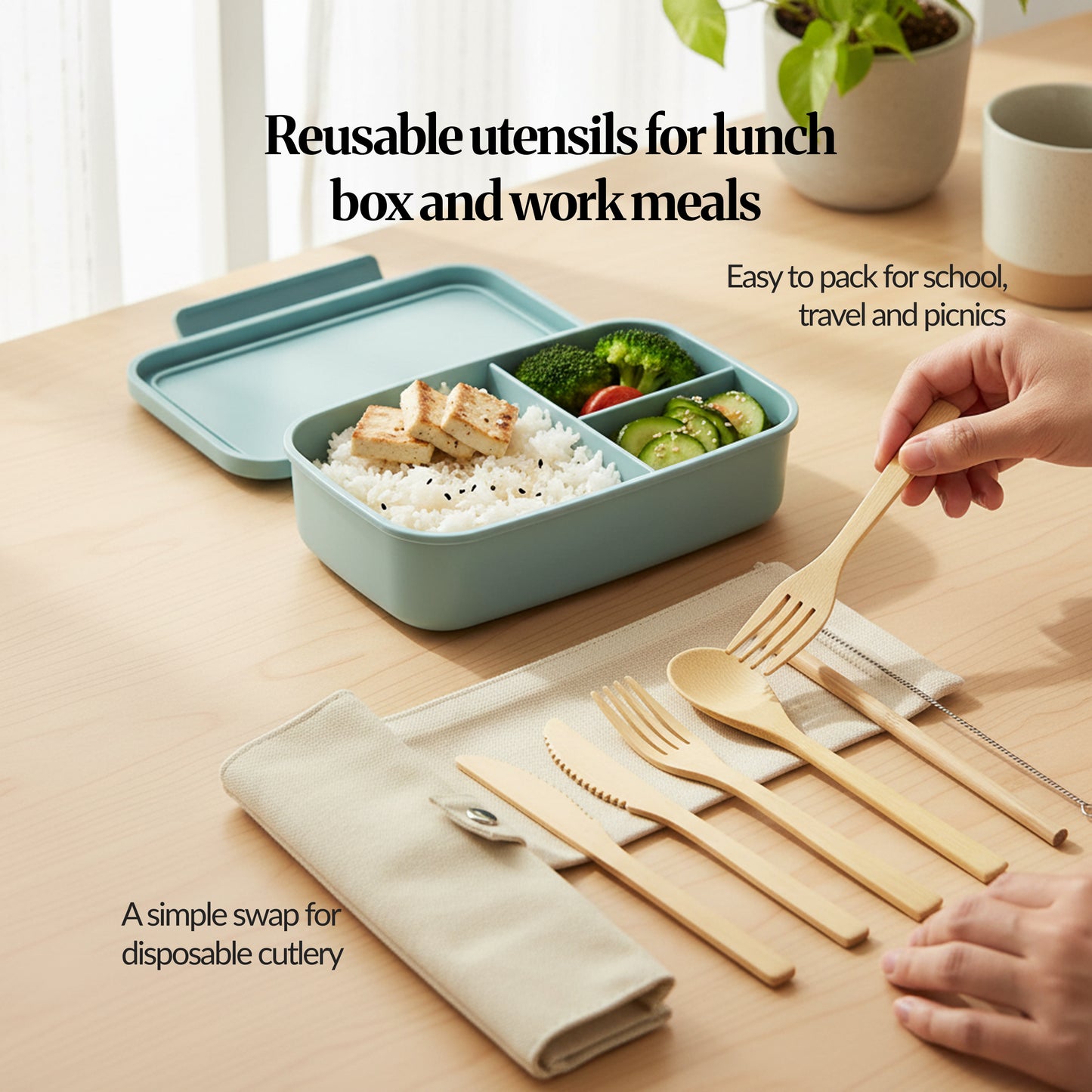Reusable bamboo cutlery set in use beside a lunch box, with hands placing the bamboo spoon and fork on the table (travel/school/picnic use case).