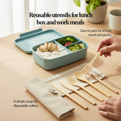 Reusable bamboo cutlery set in use beside a lunch box, with hands placing the bamboo spoon and fork on the table (travel/school/picnic use case).