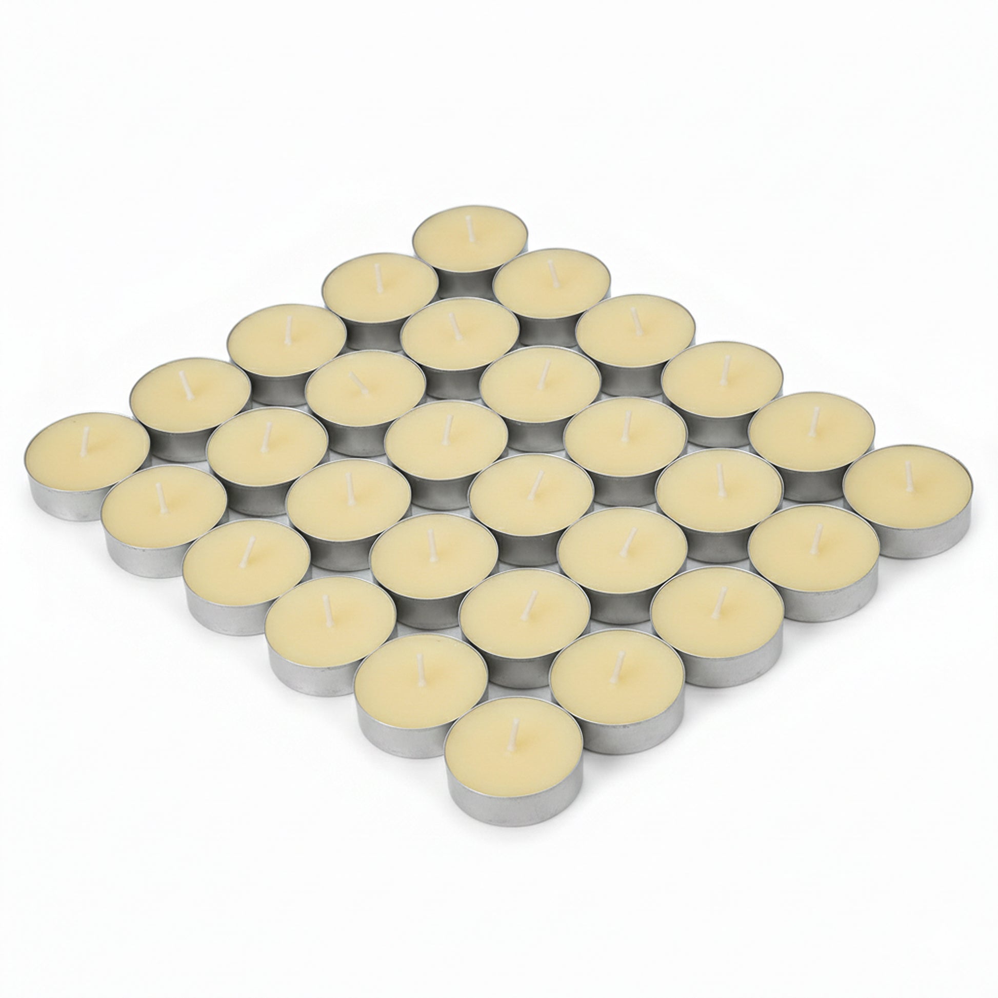 Tea lights on white background arranged in a neat cluster, showing multiple aluminium cups with pale wax and centred wicks.