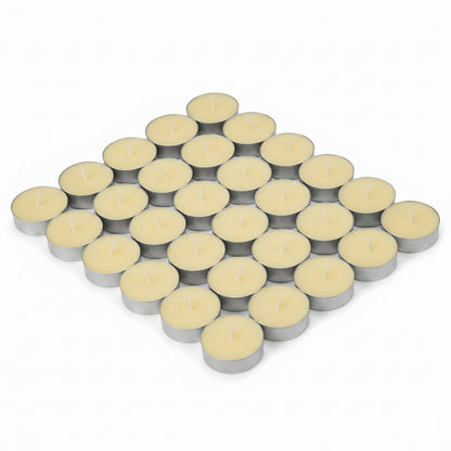 Tea lights on white background arranged in a neat cluster, showing multiple aluminium cups with pale wax and centred wicks.