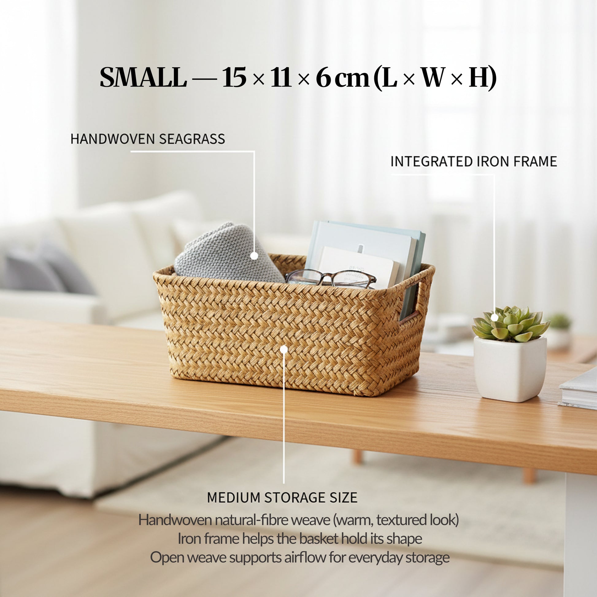 Image 04 (Variant Focus — Small): Small handwoven seagrass basket on a desk with labelled callouts for handwoven seagrass and integrated iron frame, showing size 15 × 11 × 6 cm.