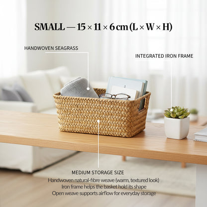 Image 04 (Variant Focus — Small): Small handwoven seagrass basket on a desk with labelled callouts for handwoven seagrass and integrated iron frame, showing size 15 × 11 × 6 cm.