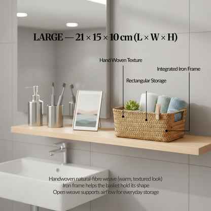 Large handwoven seagrass basket on a bathroom shelf with labelled callouts for handwoven texture, integrated iron frame, and rectangular storage, showing size 21 × 15 × 10 cm.