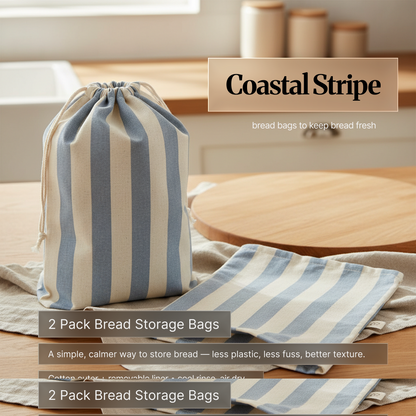 Coastal Stripe variant: blue-and-cream striped drawstring cotton bread storage bag with matching removable liner on a kitchen counter; 2-pack reusable bread bags to keep bread fresh.