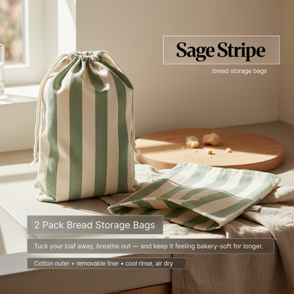 Sage green striped cotton bread storage bag set (2-pack) on a kitchen counter by a window; drawstring bag and matching liner designed to keep bread bakery-soft longer.
