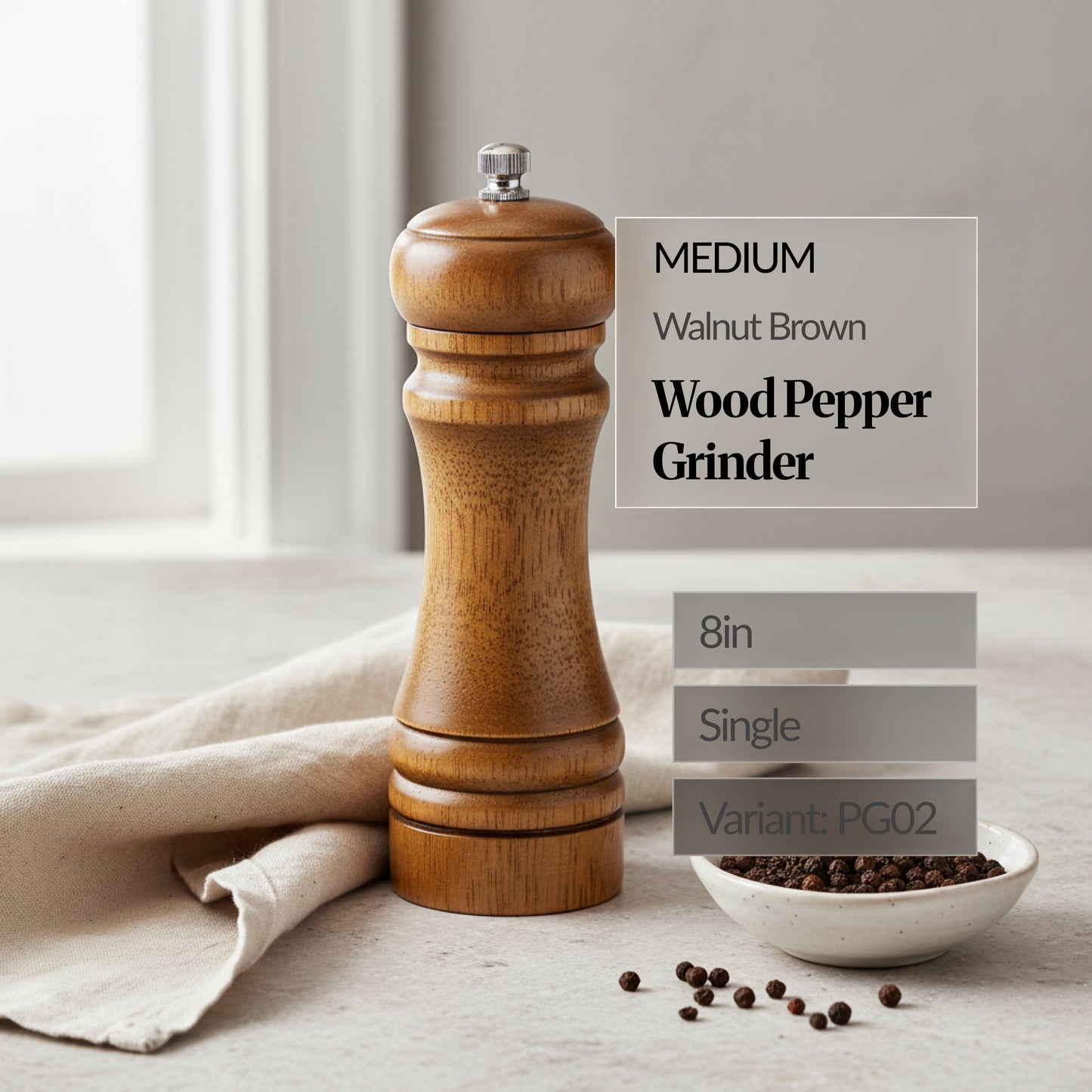 Medium 8in walnut brown wood pepper grinder (single) standing beside a small bowl of peppercorns on a soft linen cloth; text overlay shows “Variant: PG02”.
