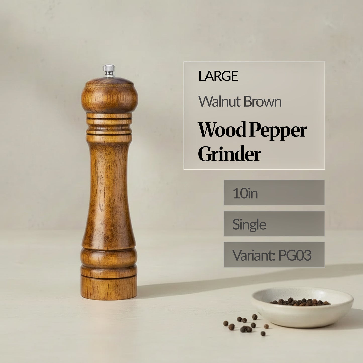 Large 10in walnut brown wood pepper grinder (single) standing on a neutral background, with peppercorns in a small dish.