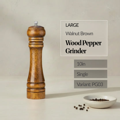 Large 10in walnut brown wood pepper grinder (single) standing on a neutral background, with peppercorns in a small dish.