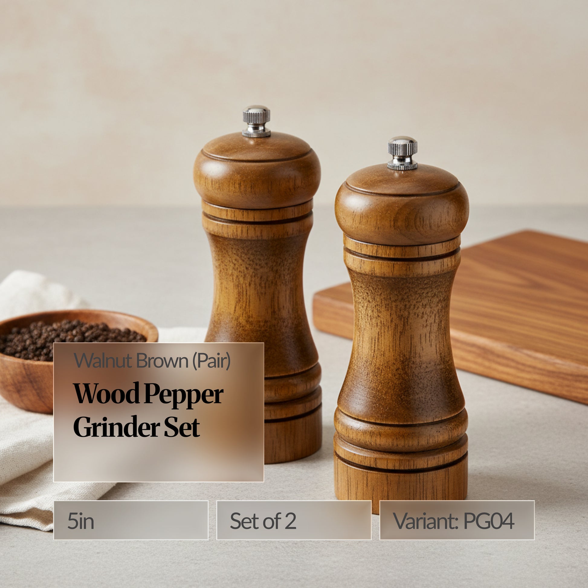 Walnut brown wood pepper grinder set of 2 (5in pair) on a kitchen counter with a wooden board and bowl of peppercorns; text overlay shows “Variant: PG04”.