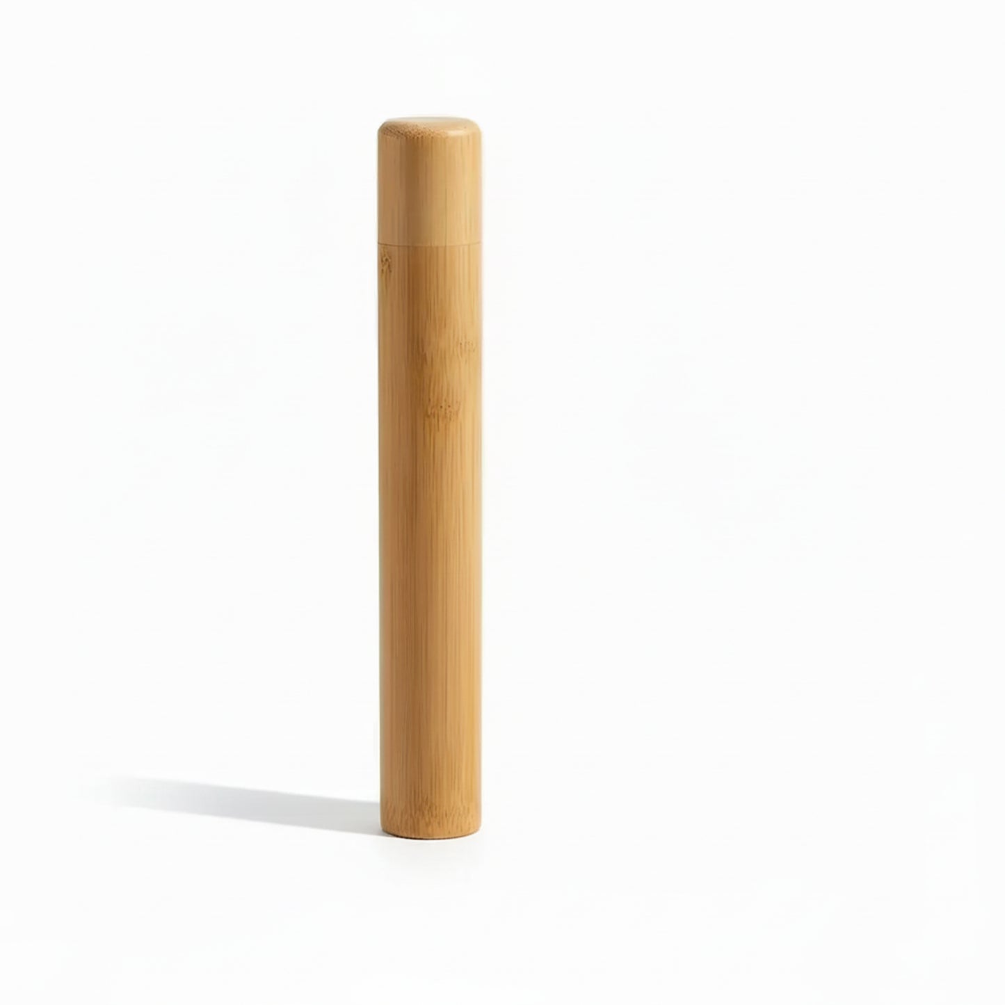 Portable bamboo toothbrush holder travel tube with matching cap and toothbrush on white background. 