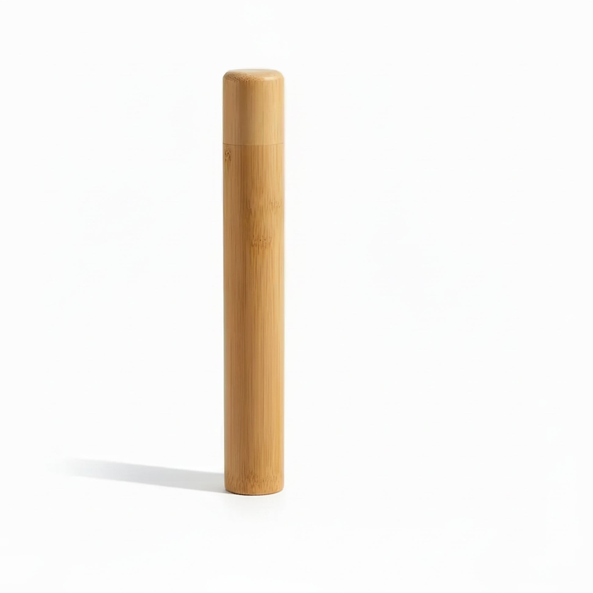 Portable bamboo toothbrush holder travel tube with matching cap and toothbrush on white background. 