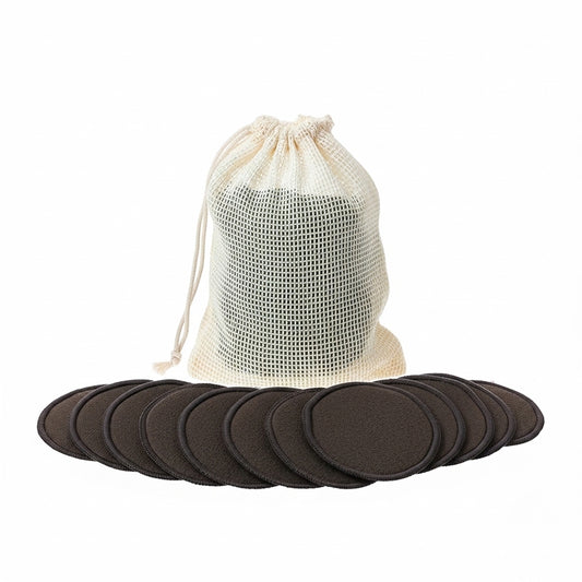 Product-only shot of black reusable cotton pads laid out with a mesh drawstring laundry bag behind.