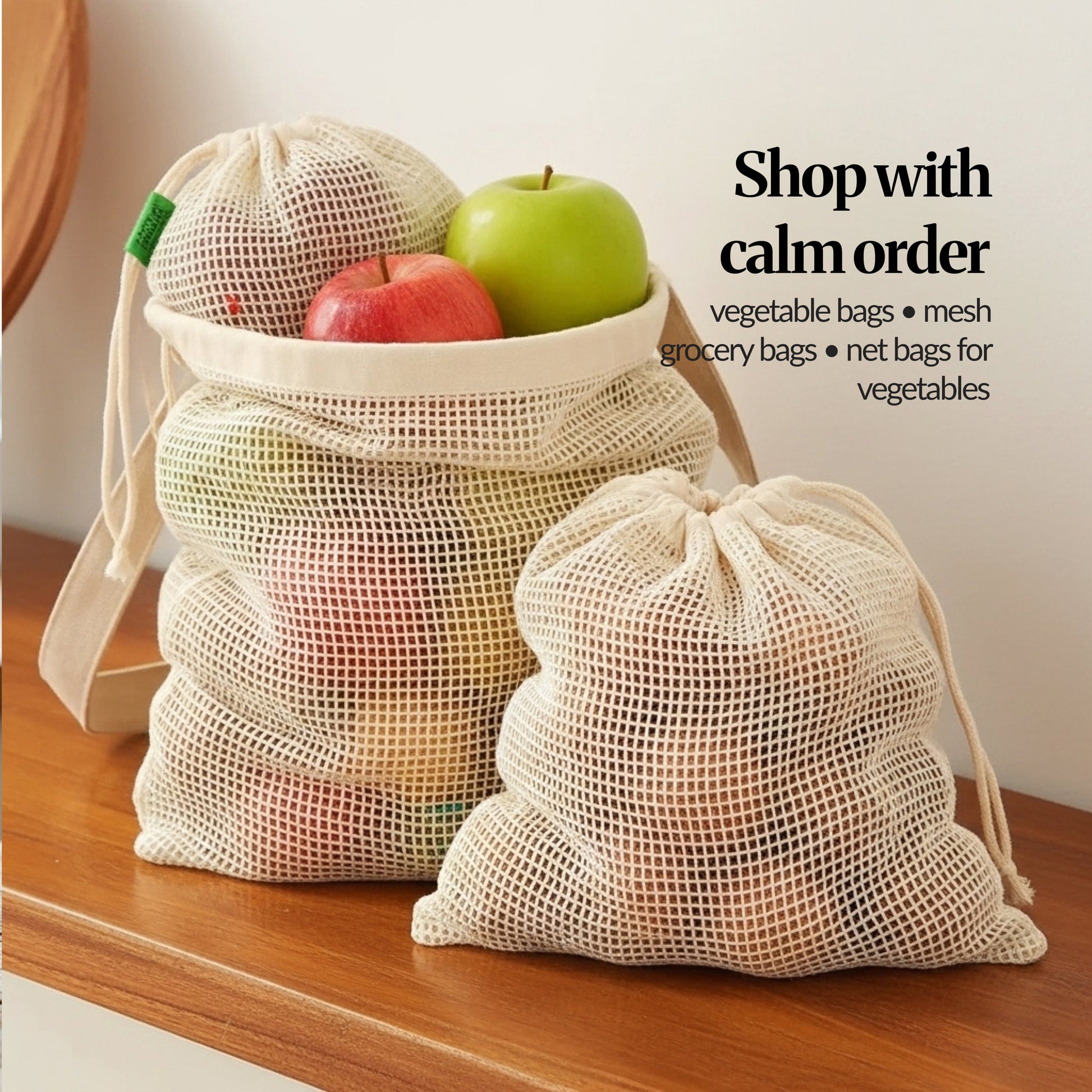 Stacked cotton mesh grocery bags filled with apples on a wooden counter, showing how the reusable produce bags hold fruit neatly.