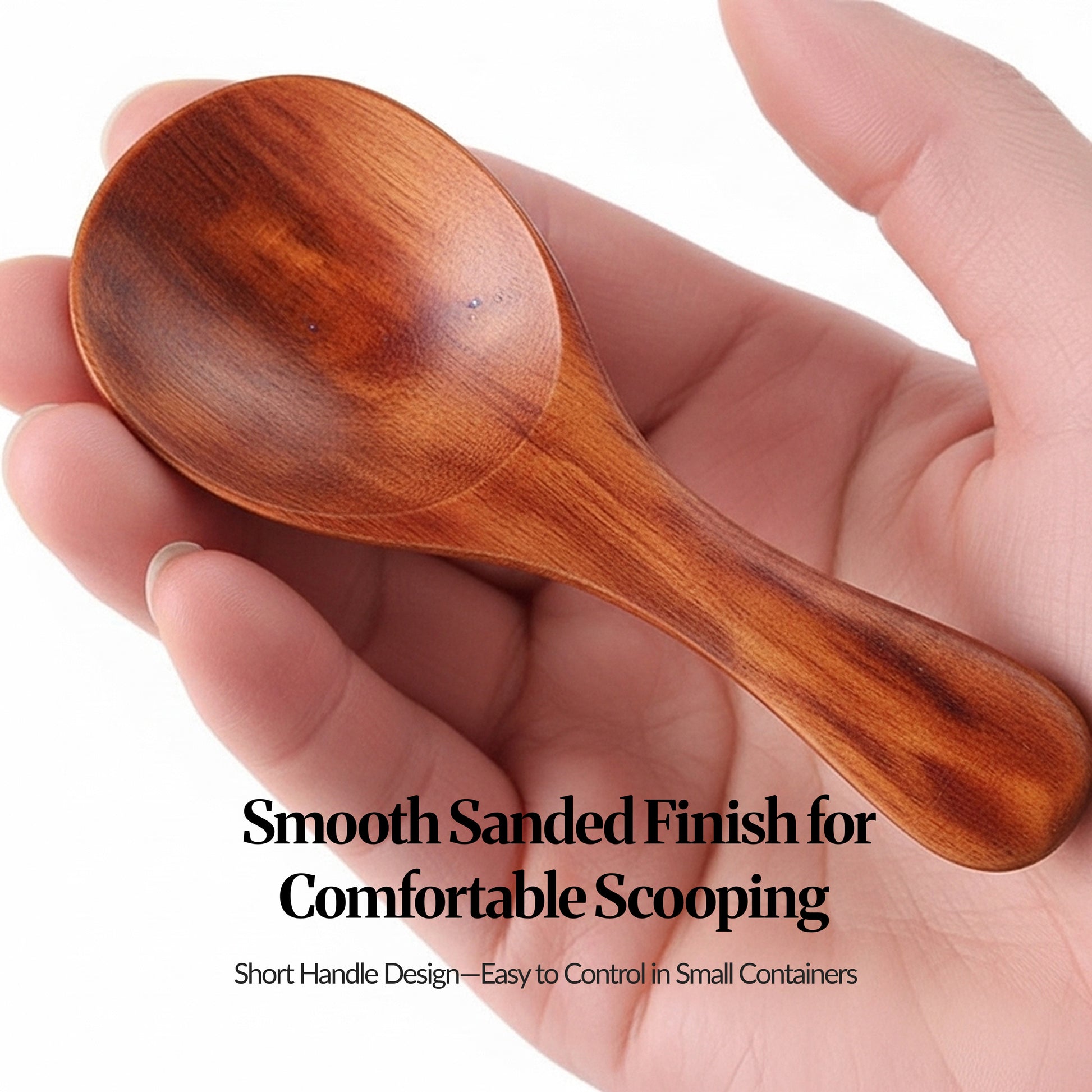 Close-up of a dark brown mini wooden scoop resting in a hand, highlighting the smooth sanded finish and short handle.