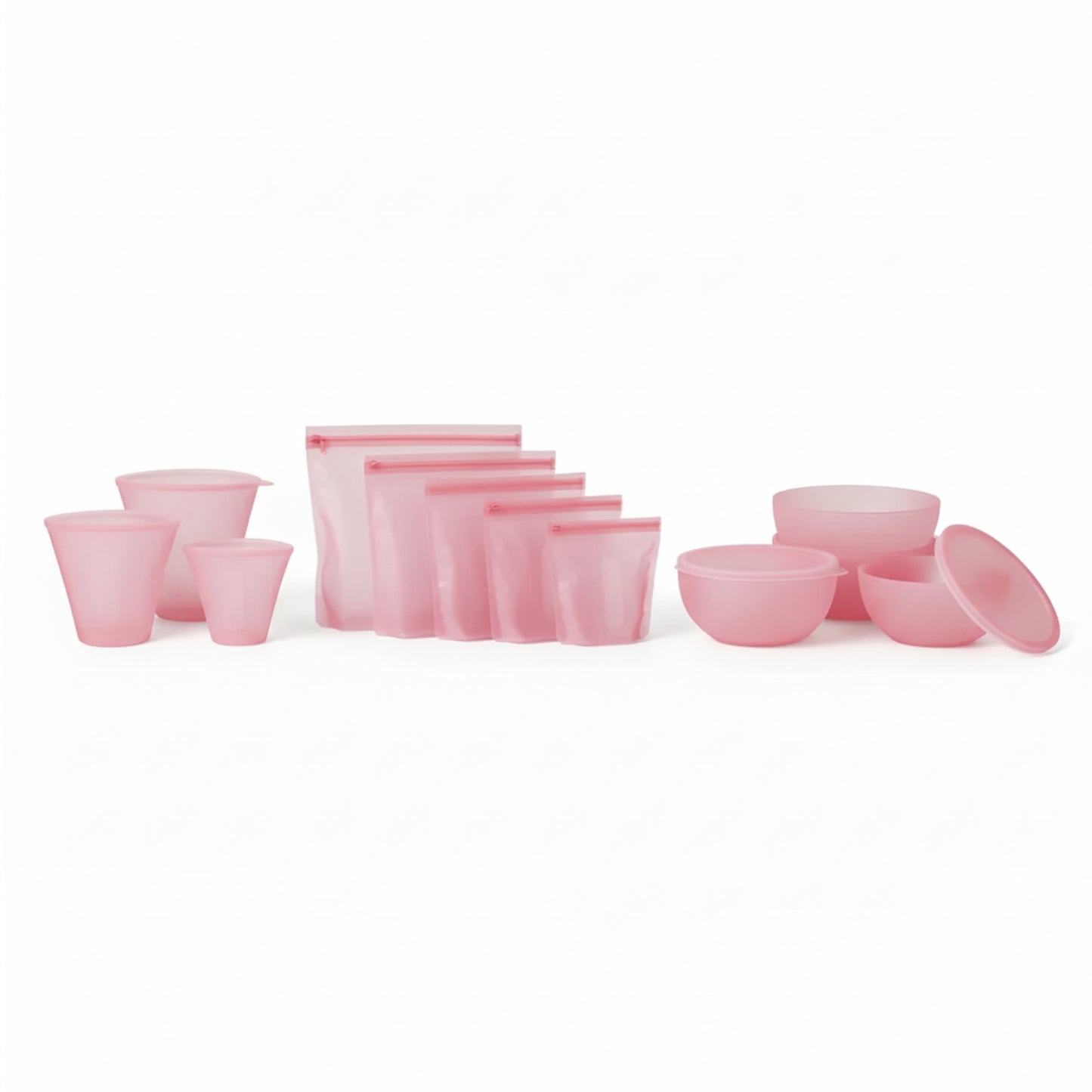 PR069 pink silicone food storage set laid out on a white background — reusable cups plus zip-top silicone bags and lidded bowls (complete set).
