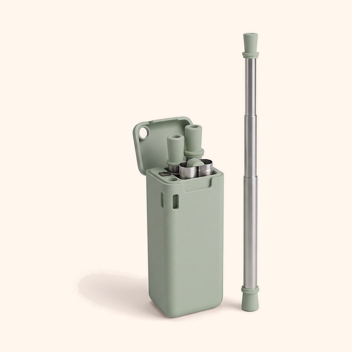 Sage green case open beside a fully extended steel straw with a green tip, on cream