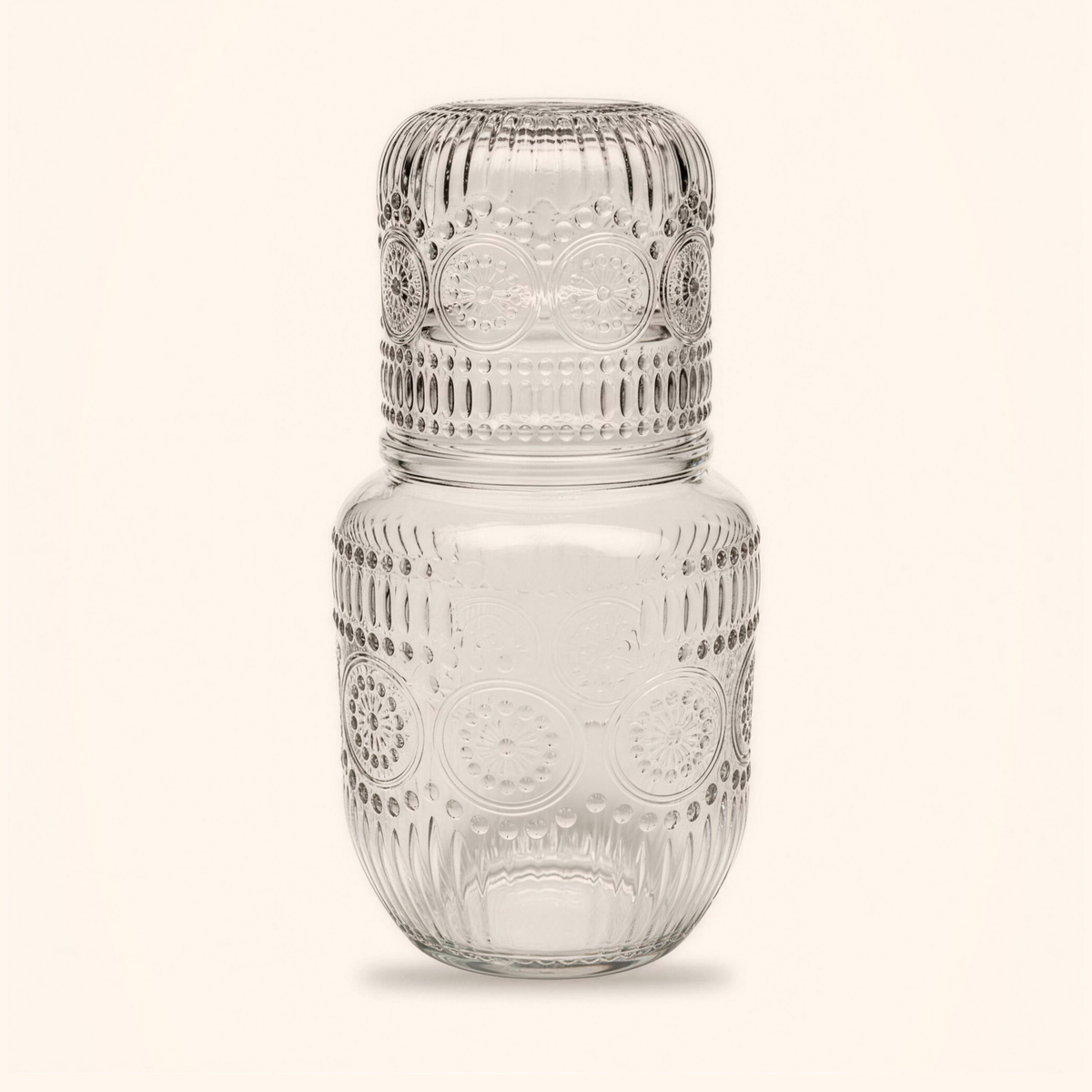 Bedside carafe and glass set in clear embossed glass, the glass resting upside down on top