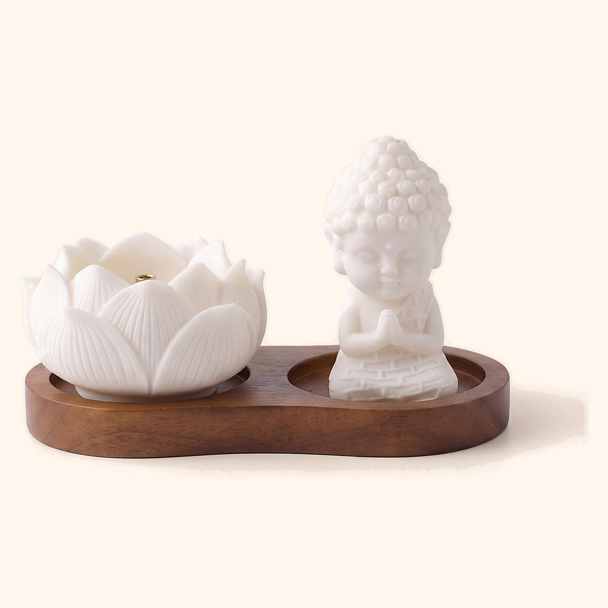 Ceramic lotus bowl and seated monk figure on a dark wooden incense tray