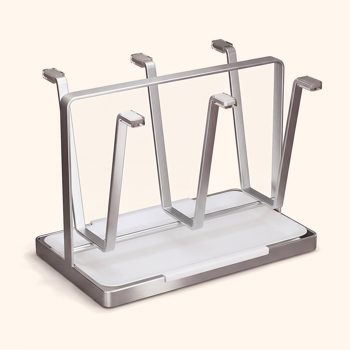 Silver cup drying rack with six arms over a white drip tray, on cream