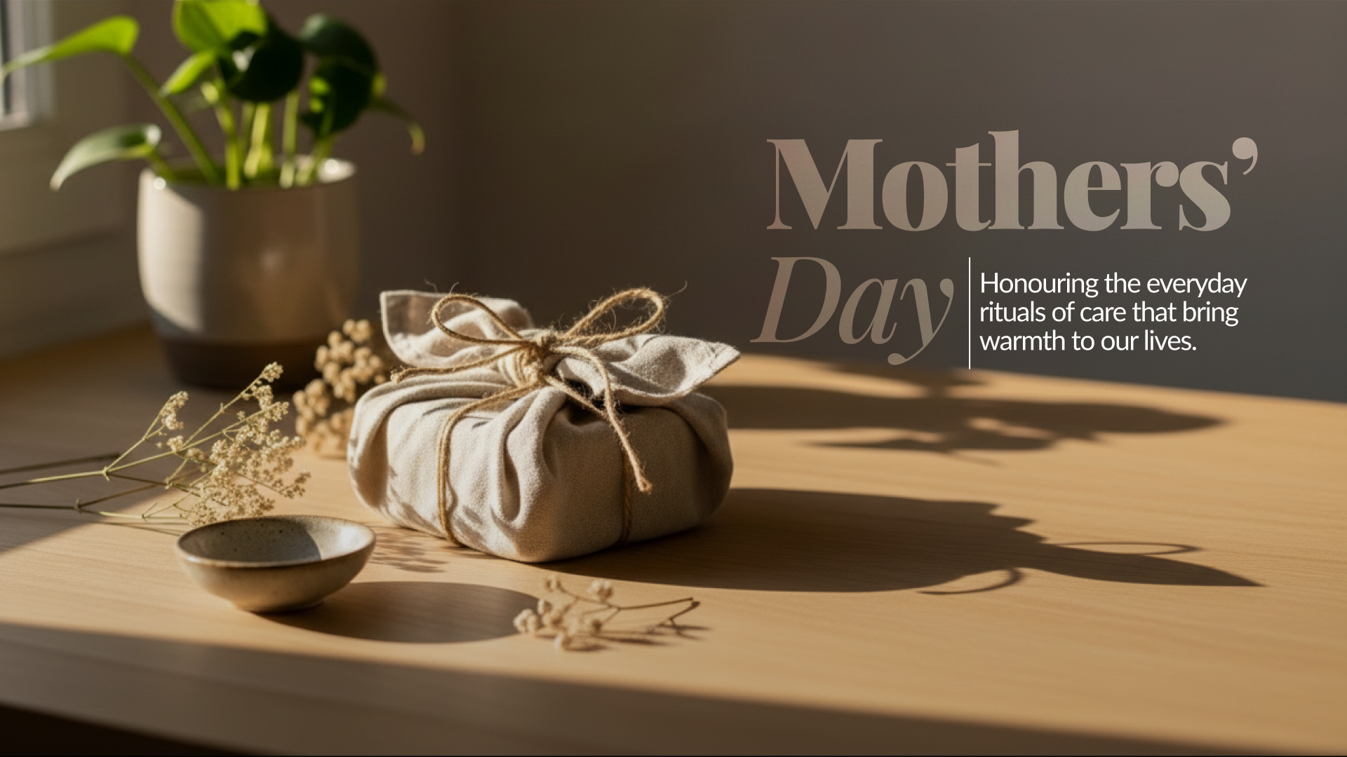 Mother’s Day banner featuring a wrapped gift on a sunlit table with the text “Mother’s Day” and “Honouring the everyday rituals of care that bring warmth to our lives.”